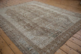 Distressed vintage Shiraz carpet with faded geometric plant motifs in coffee brown and antique ivory.