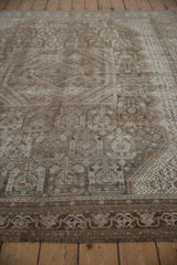 Distressed vintage Shiraz rug border with geometric patterns, textural wear, coffee brown, and pale teal.