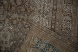 Distressed vintage Shiraz rug detail showing worn pile, exposed foundation, and teal selvage.
