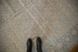 Beige and blue Herati pattern with visible abrashes on distressed Tabriz carpet.