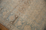 Distressed vintage Tabriz carpet showcasing beige, powder blue Herati design and visible knot wear.