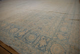 Faded beige and dusty blue Herati design on a distressed vintage Tabriz carpet border.