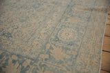 Distressed Tabriz carpet's beige and powder blue Herati motif, showing even wear and abrash.