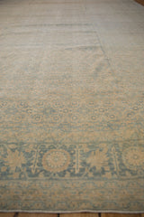 Distressed border and faded Herati pattern of a vintage Tabriz rug in beige and blue.