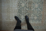 Textured wear and dynamic ivory, teal, brown colors on a distressed Malayer carpet.