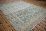 Distressed Malayer carpet border with faded geometric motifs, abrashes, and muted ivory, beige, teal.