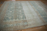 Close-up of vintage distressed Malayer carpet showing heavy abrashes and dye lot changes.