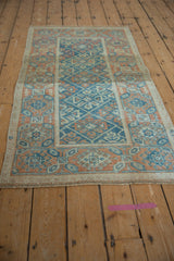 Distressed Mahal rug fringe and geometric border in sky blue, tangerine, ivory.