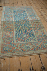 Distressed sky blue, tangerine, ivory lattice design and floral motifs on a vintage Mahal rug.