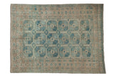 Distressed vintage Ersari carpet with faded dusty blue guls, antique ivory ground, and geometric borders. 6'8