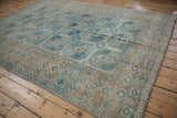 Distressed Ersari carpet with worn texture, geometric guls, and blue, ivory tones.