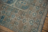 Ersari carpet's distressed pile shows faint foundation, beige and dusty blue geometric patterns.