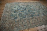Distressed Ersari carpet showing faded dusty blue guls, geometric borders, and antique ivory texture.