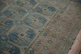 Distressed vintage Ersari rug featuring faded dusty sapphire guls and geometric border.
