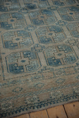 Distressed Ersari carpet border detail with worn texture, dusty blue, and sand tones.