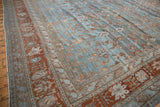 Vintage distressed Bibikabad carpet, blue field with delicate vinery, abrashes, and terracotta border.