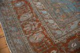 Distressed vintage Bibikabad rug corner, pale blue field with terracotta border vinery.