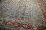 Distressed Bibikabad carpet corner, highlighting delicate vinery, abrashes, and terracotta border.