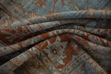 Vintage distressed Bibikabad carpet with textured pile, dusty blue, and terracotta floral motifs.