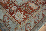 Distressed Bibikabad rug texture with vinery, blossoms, and palmettes in dusty blues and wine reds.