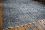Distressed vintage Sparta square carpet texture, featuring time-softened blues and ivory.
