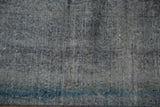 Distressed hand knotted Turkish Sparta carpet texture showing foundation wear, soft ivory, navy, and pale teal hues.