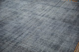 Distressed hand-knotted Sparta carpet, with texture and wear revealing dusty blues and silver.