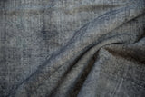 Worn pile texture of vintage Sparta carpet, revealing knot heads and faded oxidized silver.