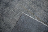 Vintage Sparta carpet's worn pale blue and ivory pile, exposed foundation, and woven reverse.