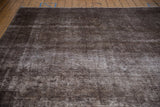 Distressed brown and charcoal texture of the vintage Sparta rug with exposed foundation.
