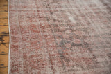 Distressed texture of vintage Sparta carpet, with faded raspberry, ivory, and oxidized silver tones.