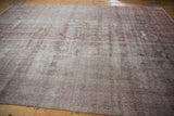Distressed Sparta carpet showcasing worn pile, visible foundation, and faded ivory and raspberry tones.