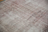 Distressed texture of a vintage Sparta rug, with foundation showing through muted raspberry and ivory.