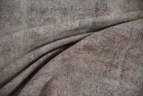 Distressed vintage Sparta carpet texture with exposed ivory and pale raspberry foundation wear.