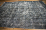 Overdyed vintage Sparta rug with textural wear; dusty dark teal, navy, and white tones.
