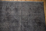 Overdyed vintage Sparta carpet's worn pile texture in charcoal and dark navy.