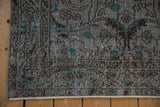 Distressed vintage Sparta rug, slate blue and turquoise floral, scrolling leaves, even wear.