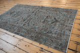 Distressed vintage Turkish Sparta rug's textural wear, slate blue, coffee brown, and turquoise scrolling florals.