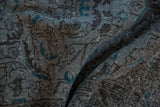 Textured detail of the distressed Sparta rug with slate blue and turquoise floral pattern, wear to knot heads.
