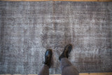 Textured pile of a distressed Sparta rug showing oxidized silver tones and exposed foundation.