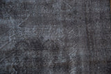 Distressed charcoal pile texture and exposed foundation on the vintage Sparta rug.