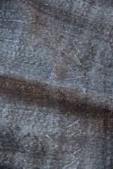 Distressed texture of the vintage Sparta rug, with visible silver and charcoal foundation.