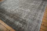 Textural detail of the vintage Meshed rug's worn pile, revealing its side selvage.