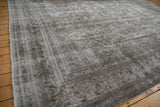 Distressed overdyed Meshed rug showcasing its low pile and muted slate grey tones.