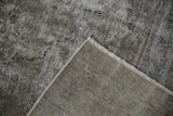 Vintage Meshed carpet corner, displaying worn pile, hand-knotted foundation, and intact fringe.