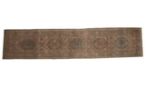 Distressed vintage Serab rug runner, 3x14, with geometric medallions in earthy neutral, dusty aqua, and rose tones.