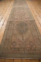 Geometric pawn motif border on distressed vintage Serab runner with dusty aqua and blush tones.