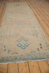Long perspective view of the vintage Persian runner, highlighting its distressed, geometric design.