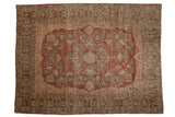Distressed vintage Sarouk carpet: faded terracotta field, scalloped medallion, intricate floral border.