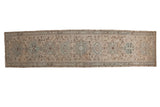 Distressed vintage Karaja runner featuring alternating geometric medallions in muted beige, silver-blue, and brown.